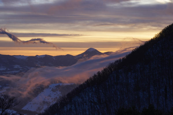 Italy, Umbria, Monte Cucco, Stormy sunrise in Winter