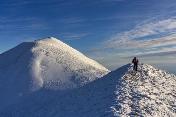 Italy, Umbria, Apennines, Mount Acuto, Hiker near the summit in Winter
