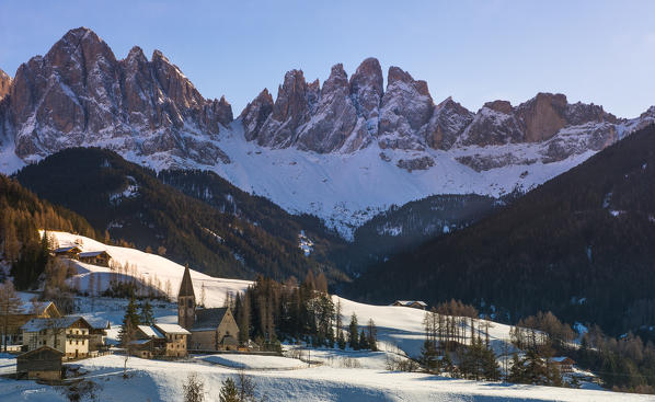 The church of Santa Maddalena in Val di Funes and the Odle mountains at sunset in a Winter day, Val di Funes, Dolomites, Italy