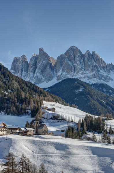 The church of Santa Maddalena in Val di Funes and the Odle mountains at sunset in a Winter day, Val di Funes, Dolomites, Italy