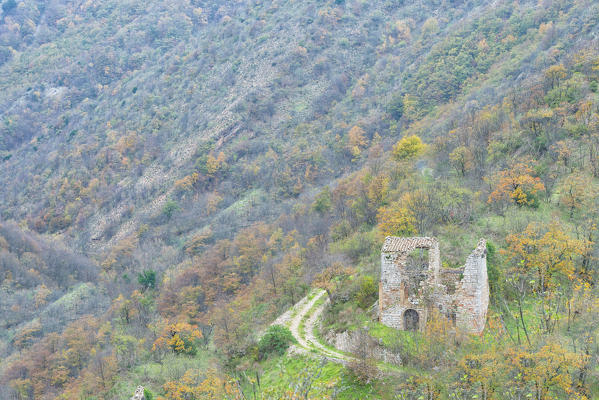 Old ruin in the woods in Autumn with foliage, Monte Cucco NP, Appennines, Umbria, Italy