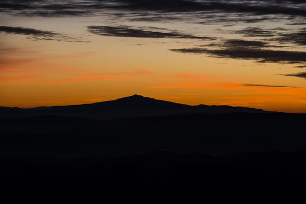 Silhouette of mount Amiata at sunset in Winter, Apennines, Umbria, Italy