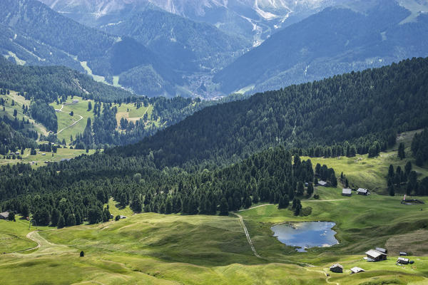 Aerial view of Lech Sant (lake Saint) and chalets, Seceda, Odle mountain range, Dolomites, Sudtirol, Italy