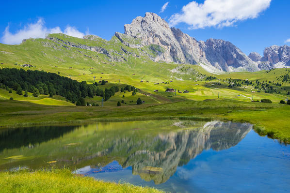 Seceda peak reflected in lake Lech Sant, Odle range, Dolomites, Italy