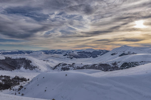 Italy, Umbria, Sibillini NP, Sunset on plateau Piano Grande of Castelluccio di Norcia  in Winter