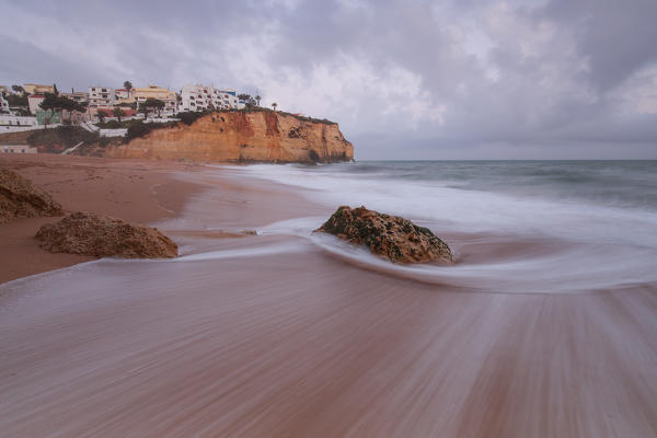 View of Carvoeiro village surrounded by sandy beach and clear sea at dusk Lagoa Municipality Algarve Portugal Europe