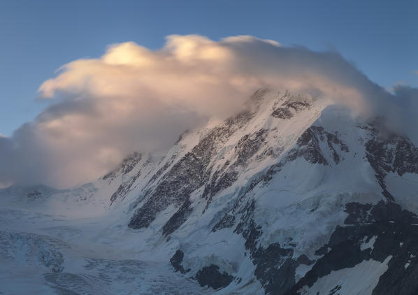 View at dawn of the mountain Liskamm covered by clouds and Lis glacier part of the Mount Rosa massif. Zermatt Canton of Valais Pennine Alps Switzerland Europe