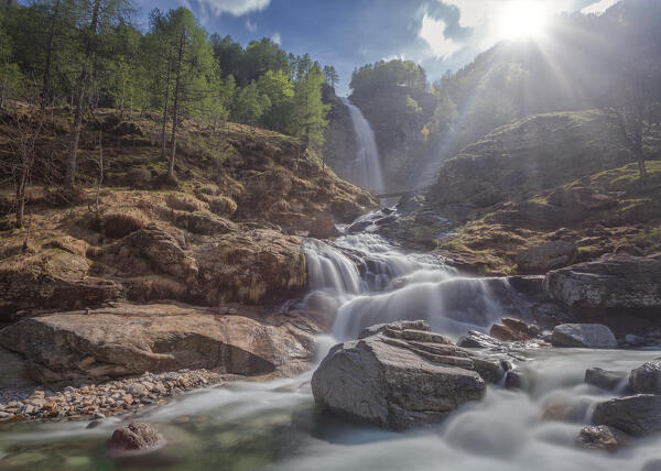 sunburst over Froda waterfall, Sonogno, Verzasca valley, Canton Ticino, Switzerland,europe