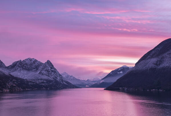 Delicated pink pastel dawn over lake lugano after a snowfall, in background monte Legnone and the mountain of lake Como, Italian switzerland border,Gandria,ticino district,Lugano,Switzerland, europe