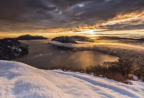 Lugano city and Lake Lugano at sunset after snowfall seen from the top of monte Bre, Canton of Ticino, Switzerland, Europe