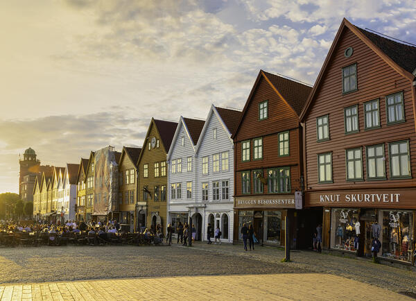Tourists walking in Bryggen Old Town at sunset, Bergen, Hordaland County, Norway