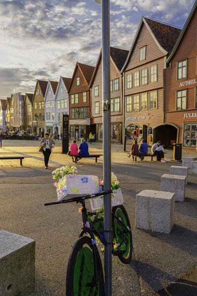 Tourists walking in Bryggen Old Town at sunset, Bergen, Hordaland County, Norway