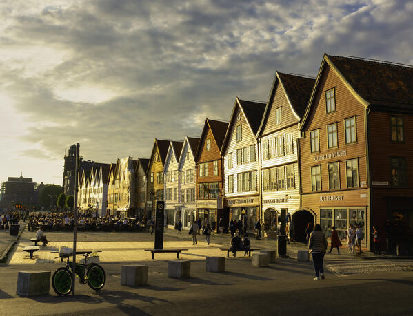 Tourists walking in Bryggen Old Town at sunset, Bergen, Hordaland County, Norway