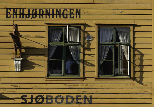 Yellow wood facade of old building Bryggen, Bergen, Hordaland County, Western Fjords region, Norway