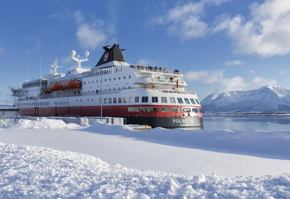  A cruise liner Hurtigruten is docked in Risøyhamn harbor in island of Andøya in Nordland county, Norway.