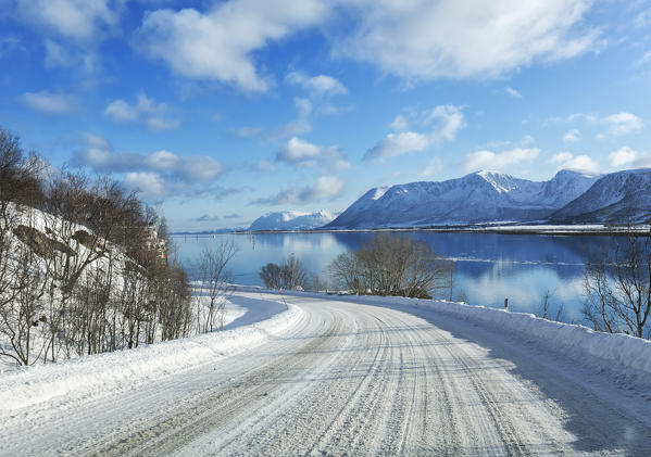 Andøy road for Andenes in winter on the Risøysundet fiord near Risøyhamn, vesteralen Nordland county, Norway.