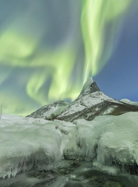 Northern lights over frozen river and over the Norway's national mountain called Stetind,tysfjord Nordland county Norway Europe