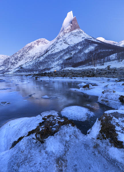 Twilight on frozen sea in  Tysfjord and over Norway's national mountain called Stetind,tysfjord Nordland county Norway Europe