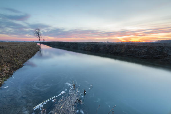 Ditch in the sunset, Lomellina, Province of Pavia, Lombardy, Italy