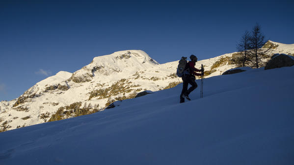 An hiker in silhouette, climbing a snowy slope. (Val d'Ayas, Vallée d'Aoste, Italy)