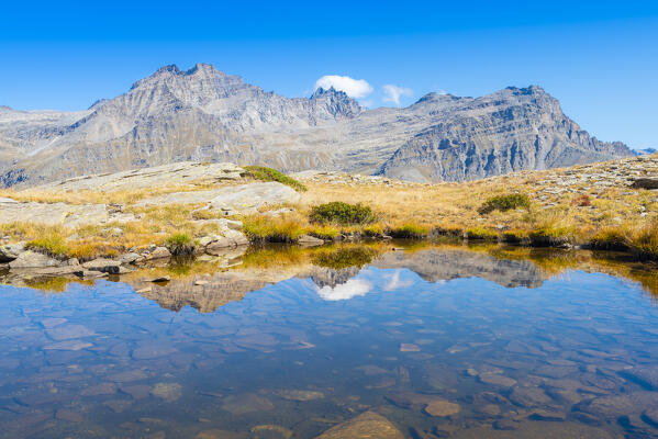 A solitary lake with Mare Percià and Testa di Entrelor mirrored in it, Orco valley, gran paradiso national park, piedmont, italian alps, italy