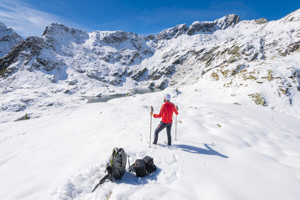 Alpinist in front of Chilet lake basin, Alleigne valley, Champorcher valley, Aosta Valley, italian alps, Italy