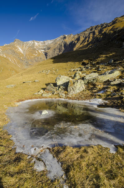 Little alpine lake frozen (Soana Valley, Gran Paradiso National Park, Piedmont, Italy)