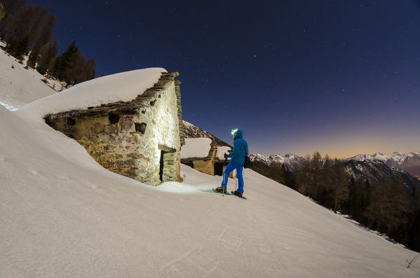 Hiker in front of Alpe Il Rono (Divedro valley, Ossola, Piedmont, Italian alps)