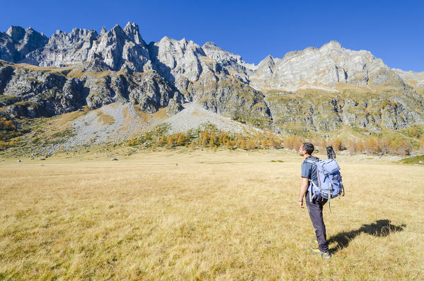 Hiker in Val Buscagna, under the spiers of Cornera, Alpe Devero, Ossola, Piedmont, Italian alps, Italy