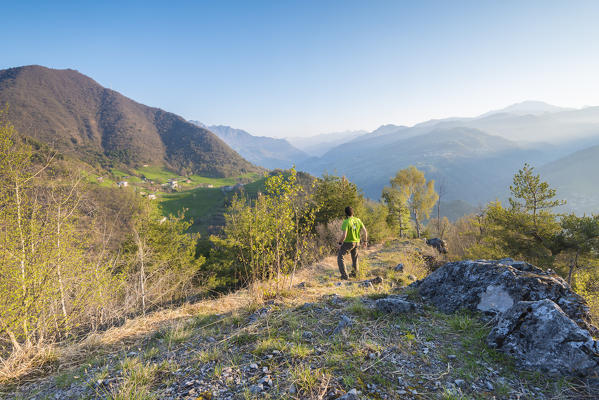 Hiker on the ridge of Pizzo del Sole at sunrise, Val Brembana, Province of Bergamo, Orobie alps, Italian alps, Italy (MR)