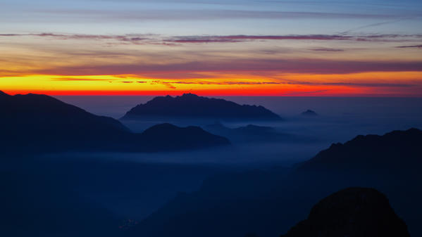 Sunrise light and sea of clouds in Valbrembana, Orobie, Lombardy, Italy