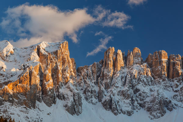 Carezza lake, Nova Levante, Ega valley, Dolomites, Bolzano province, Trentino Alto Adige, Italy. The Latemar spiers at sunset