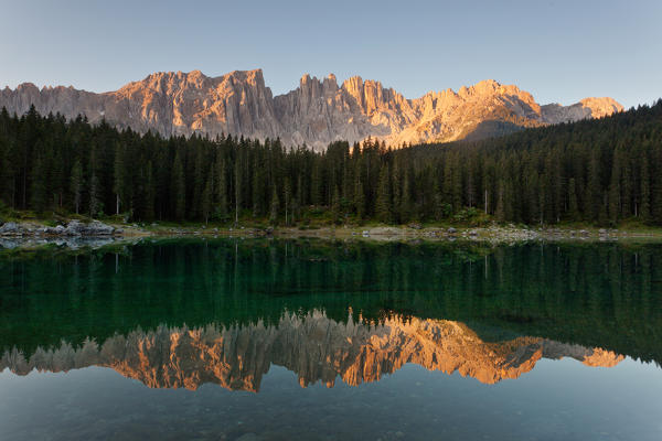 Carezza lake, Dolomites, Trentino-Alto Adige, Italy. Latemar group are reflected into the Carezza's lake in the sunrise