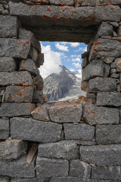 Val Genova, Adamello-Brenta natural park, Trento province, Trentino-Alto Adige, Italy. View of the Three Lobbie from a cabin's window built during the World War I.