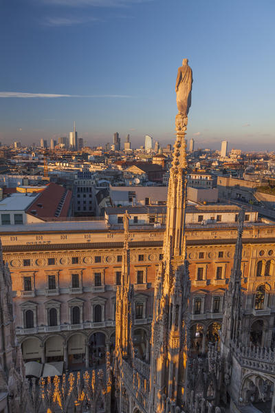 Milan, Lombardy, Italy. A spire of the cathedral and panorama of Milan city