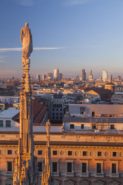 Milan, Lombardy, Italy. A spire of the cathedral and panorama of Milan city