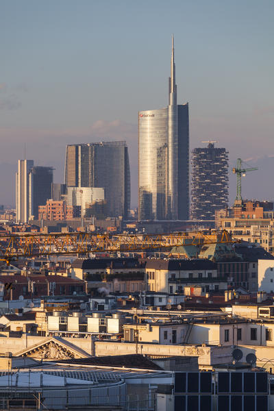 Milan, Lombardy, Italy. A view of city from the top of Cathedral at sunset.