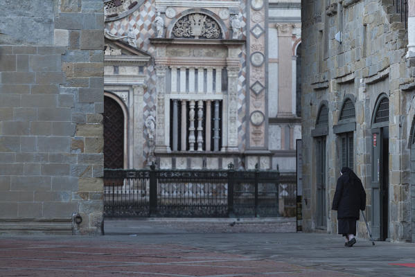 Bergamo, Lombardy, Italy. A nun in old square