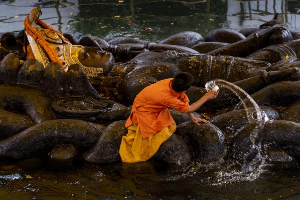 Washing of sleeping Vishnu statue at Budanilkantha, Kathmandu, Nepal. Nepalese, Asia, Asian, Himalayan Country, Himalayas.