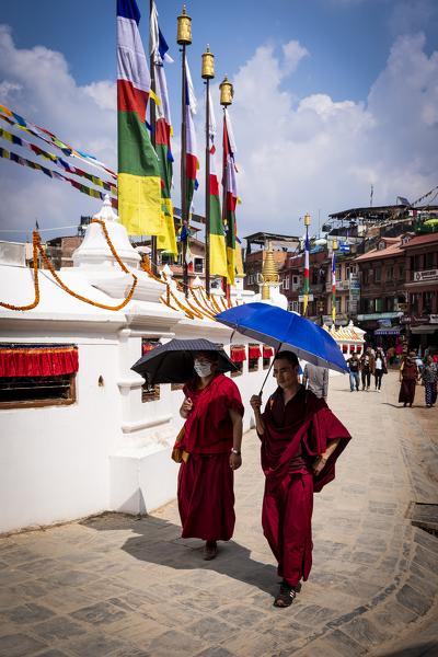 Two monks walking around the Boudhanath Stupa, the Nepal's largest and most important Buddhist monument, Kathmandu, Nepal, Nepalese, Asia, Asian, Himalayan Country, Himalayas.