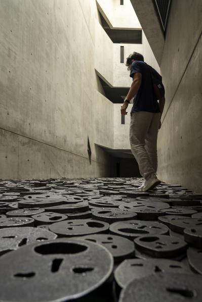 Man walking on the masks on the floor, Jewish Museum, Berlin, Germany, Europe, West Europe