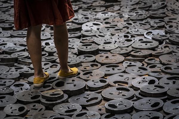 Woman walking on the masks on the floor, Jewish Museum, Berlin, Germany, Europe, West Europe