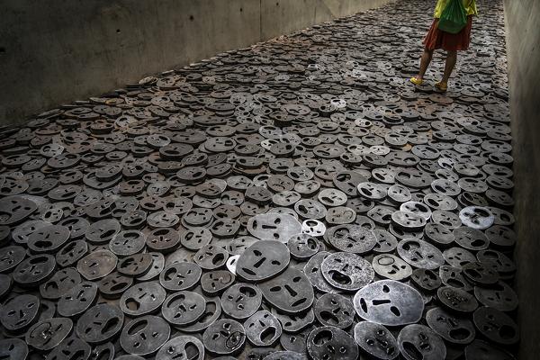 Woman walking on the masks on the floor, Jewish Museum, Berlin, Germany, Europe, West Europe