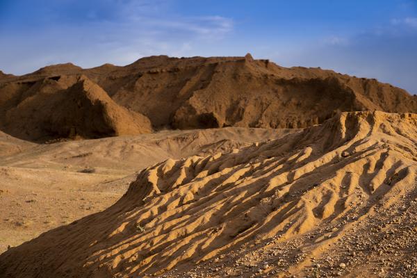 The orange rocks of Bayan Zag, commonly known as the Flaming Cliffs in the Gobi desert, Mongolia where important dinosaur fossils were found, Mongolia, Mongolian, Asia, Asian.