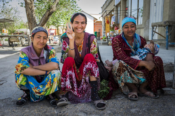 Vobkent, Bukhara, Uzbekistan, Central Asia. Women with colorful traditional dress.