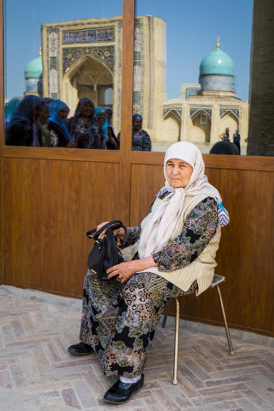 Tashkent, Uzbekistan, Central Asia. Woman with traditional dress close Madrasa Barak Khan.