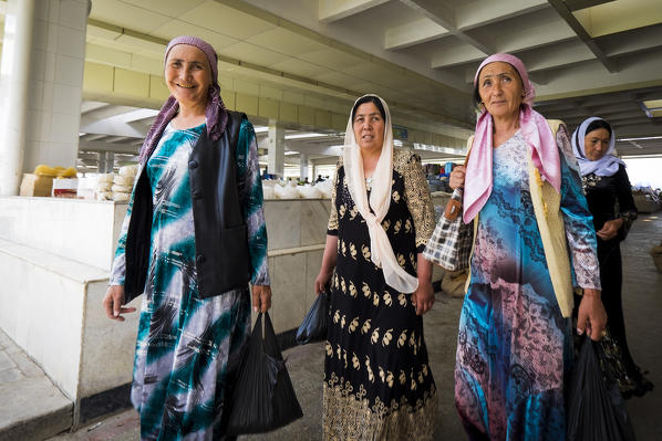 Samarkand, Uzbekistan, Central Asia. A group of women with traditional dress at the grocery market.