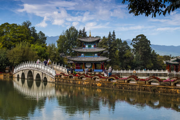 Tourists over arched bridge at Black Dragon Pool, Lijiang, Yunnan Province, China, Asia, Asian, East Asia, Far East