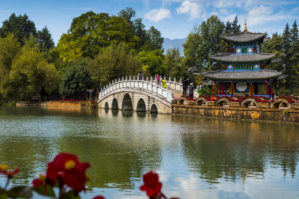 Tourists over arched bridge at Black Dragon Pool, Lijiang, Yunnan Province, China, Asia, Asian, East Asia, Far East