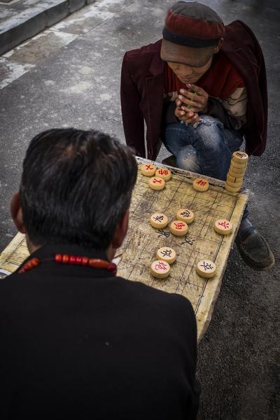 Two people playing in street of Zhongdian, Shangri-La County, Yunnan Province, China, Asia, Asian, East Asia, Far East